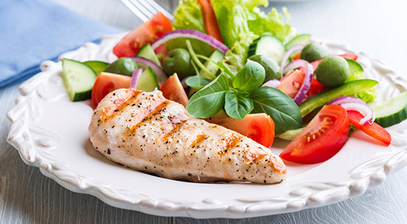 Plate with grilled chicken and salad with vegetables